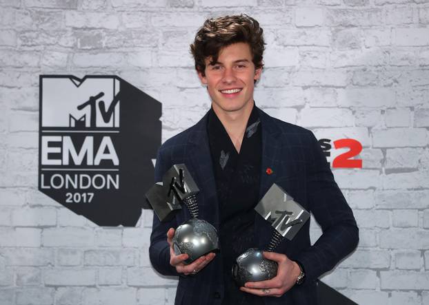 Canadian singer Shawn Mendes poses with his awards during the 2017 MTV Europe Music Awards at Wembley Arena in London