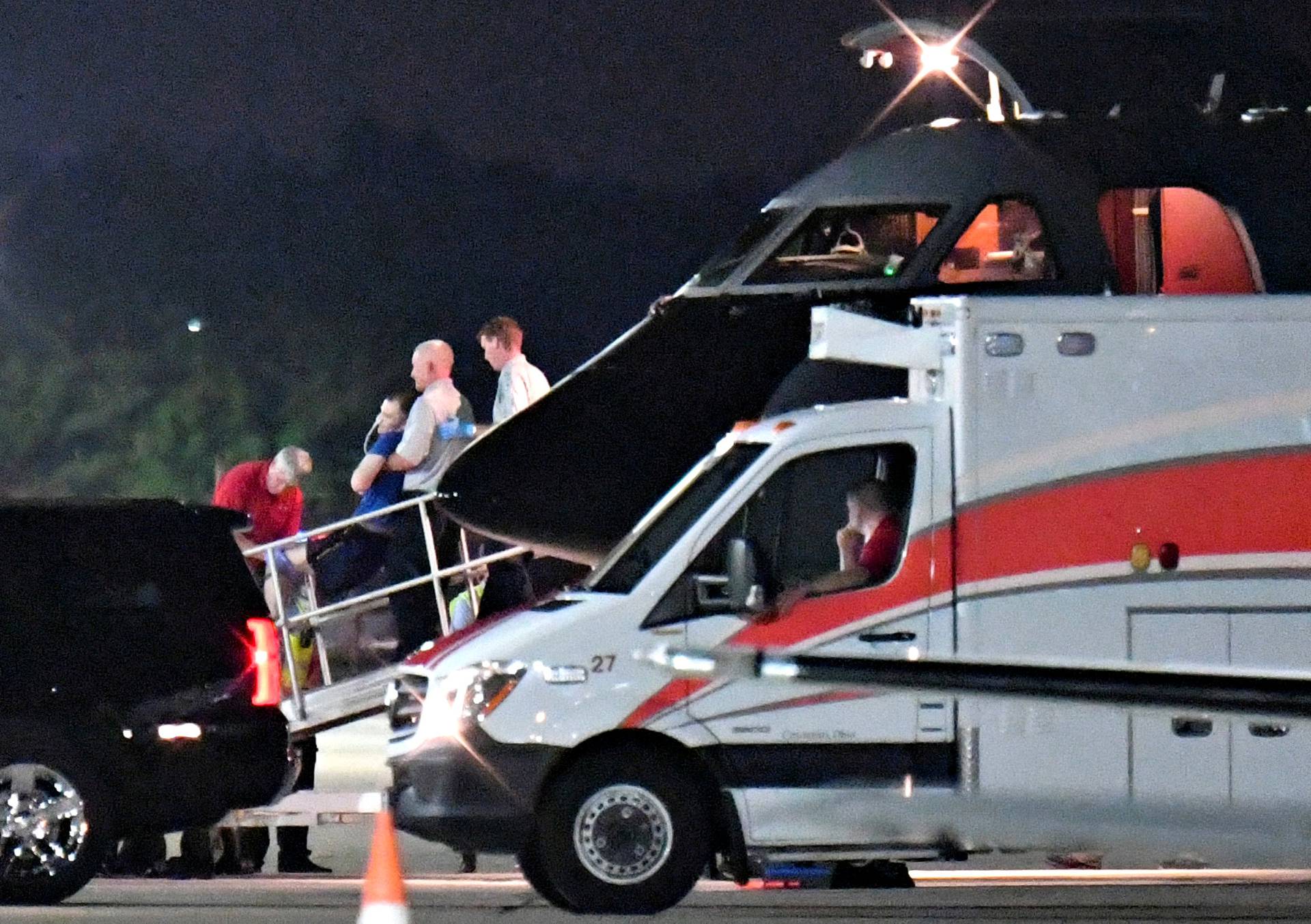 FILE PHOTO: A person believed to be Otto Warmbier is transferred from a medical transport airplane to an awaiting ambulance at Lunken Airport in Cincinnati