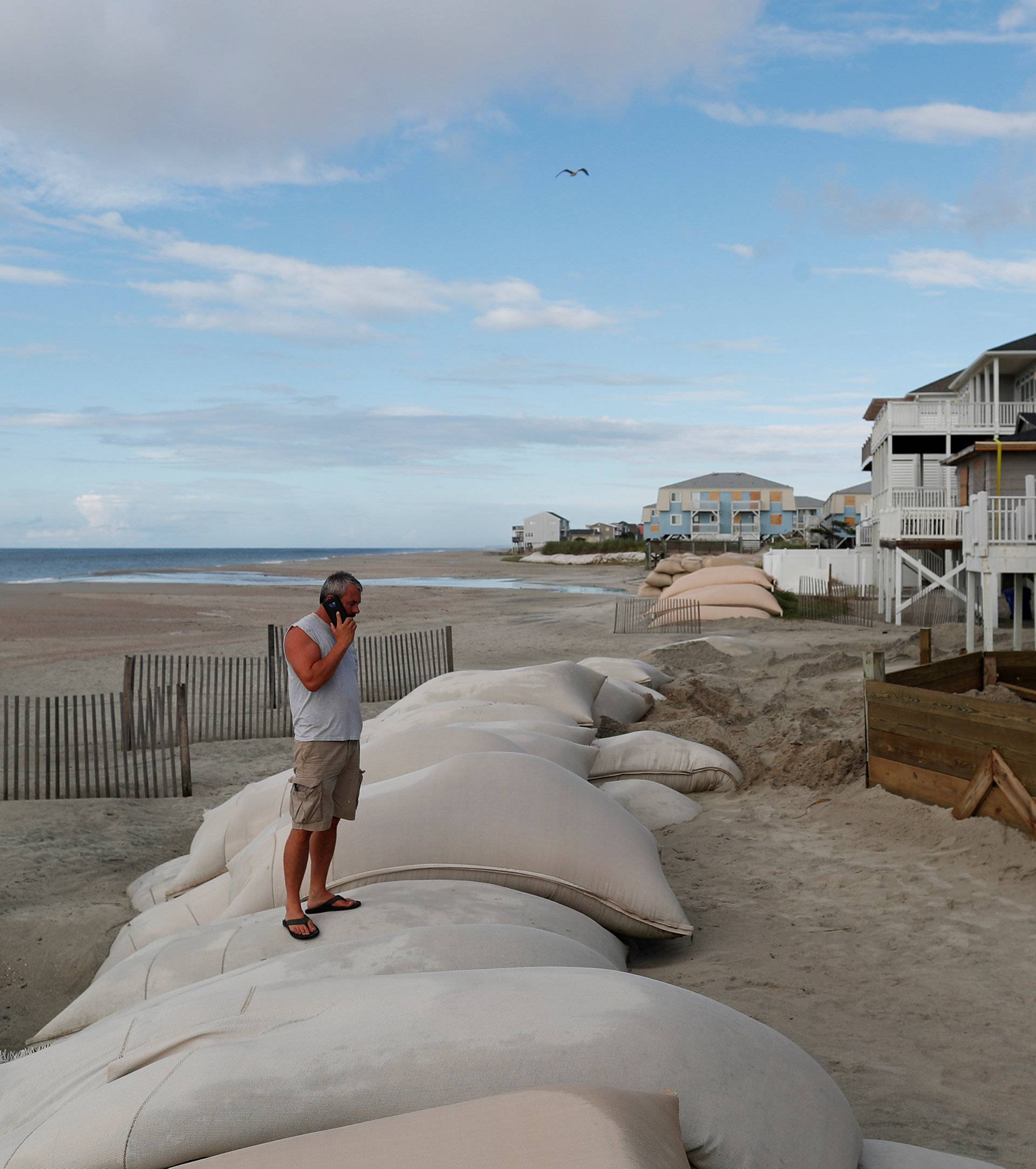 Dennis Kernodle talks on the phone during storm preparations of his oceanfront home ahead of the arrival of Hurricane Florence in Ocean Isle Beach