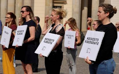 People working in the wedding industry protest against restrictions in the business in front of the Brandenburg Gate, following the coronavirus disease (COVID-19) outbreak in Berlin