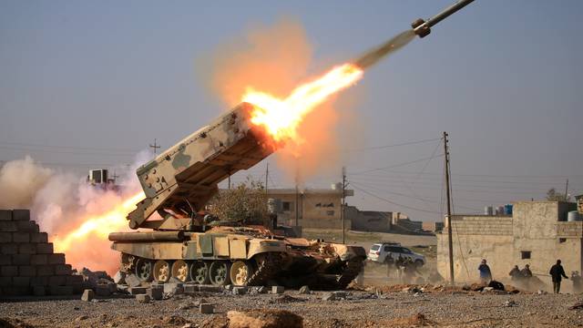 Iraqi army launch a rocket towards Islamic State militants during a battle with Islamic State militants near Ghozlani military complex, south of Mosul