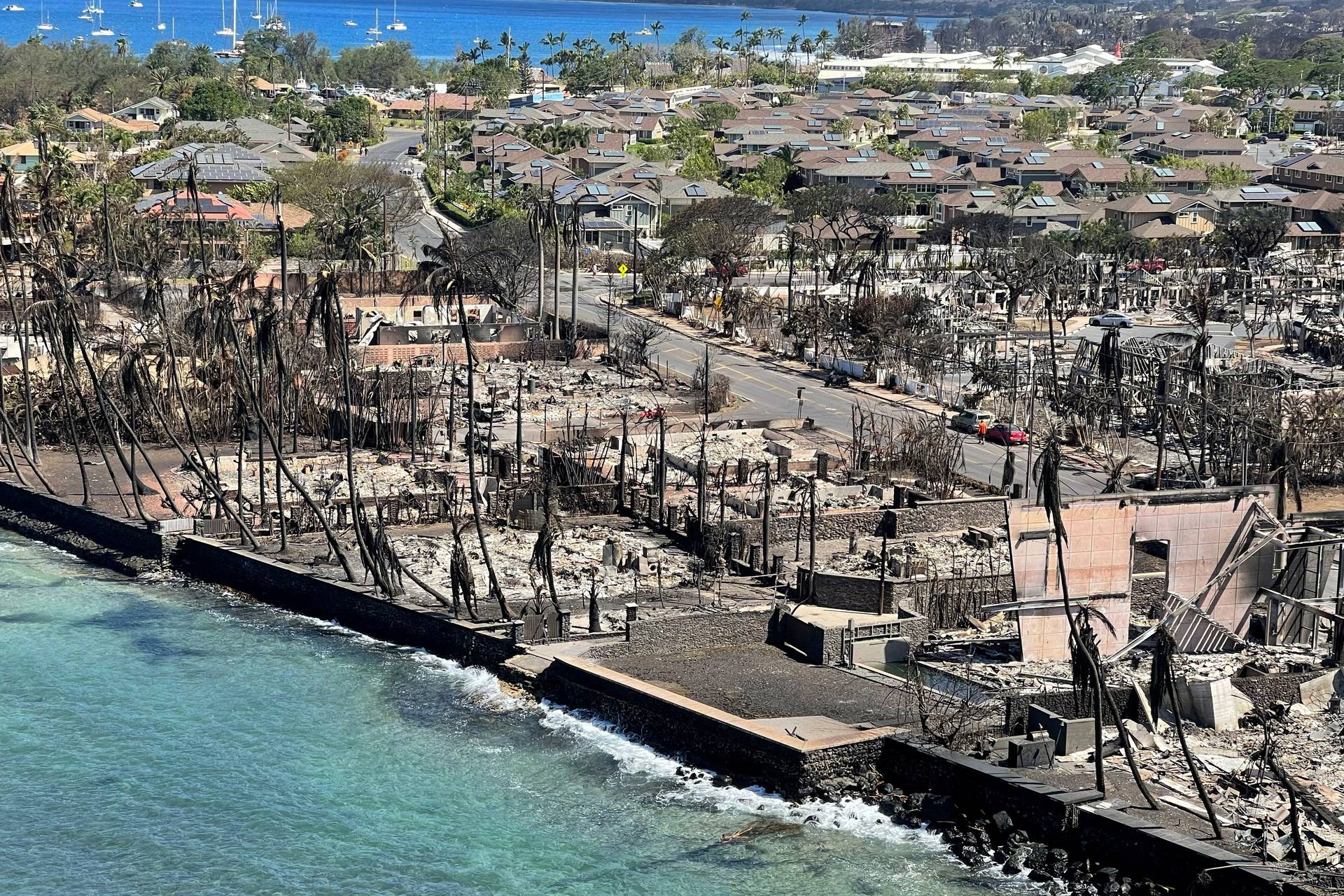 The shells of burned houses and buildings are left after wildfires in Lahaina