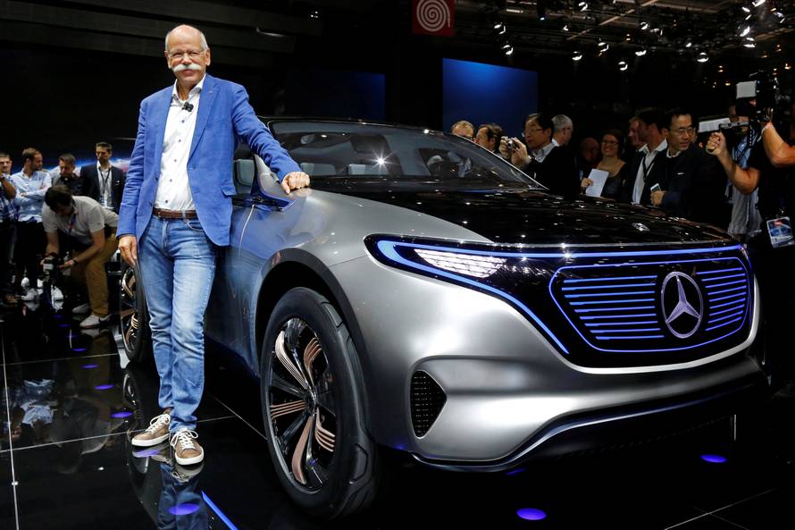 Dieter Zetsche, CEO of Daimler and Head of Mercedes-Benz, poses in front of a Mercedes EQ Electric car at the Paris auto show in Paris