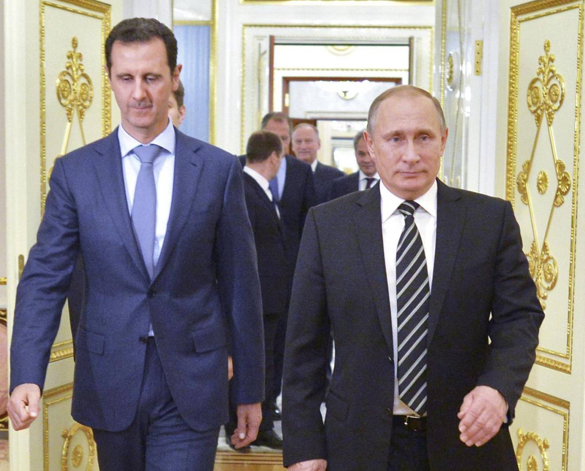 Russian President Vladimir Putin and Syrian President Bashar al-Assad enter a hall during a meeting at the Kremlin