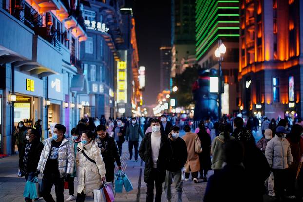 People wearing face masks are seen at a main shopping area almost a year after the global outbreak of the coronavirus disease (COVID-19) in Wuhan