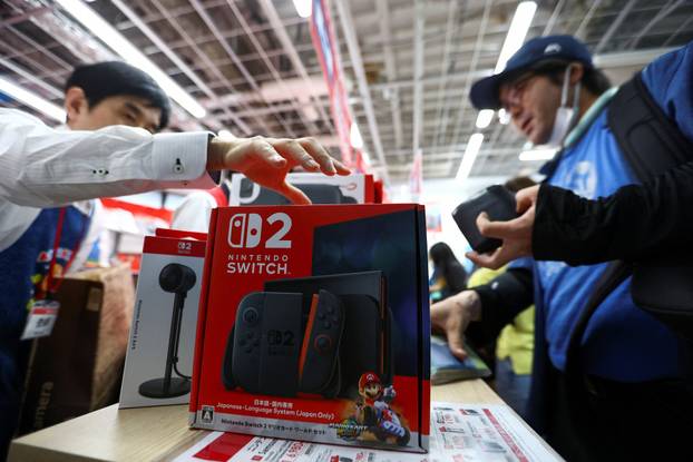 Customers line up to get the Nintendo Switch 2 as the Nintendo starts selling the new consoles globally, in Tokyo