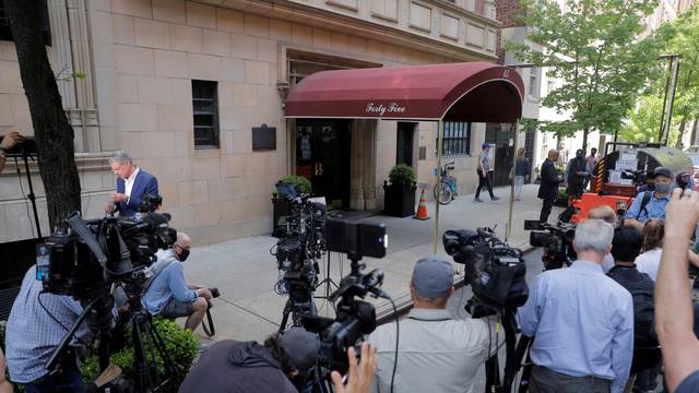 Members of the media are seen outside the apartment building of Former New York City Mayor Rudy Giuliani, personal attorney to U.S. President Donald Trump, in Manhattan, New York City, New York