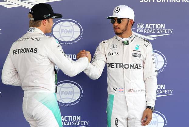 German driver Rosberg of Mercedes greets British driver Hamilton of Mercedes at the end of the qualifying for Mexico