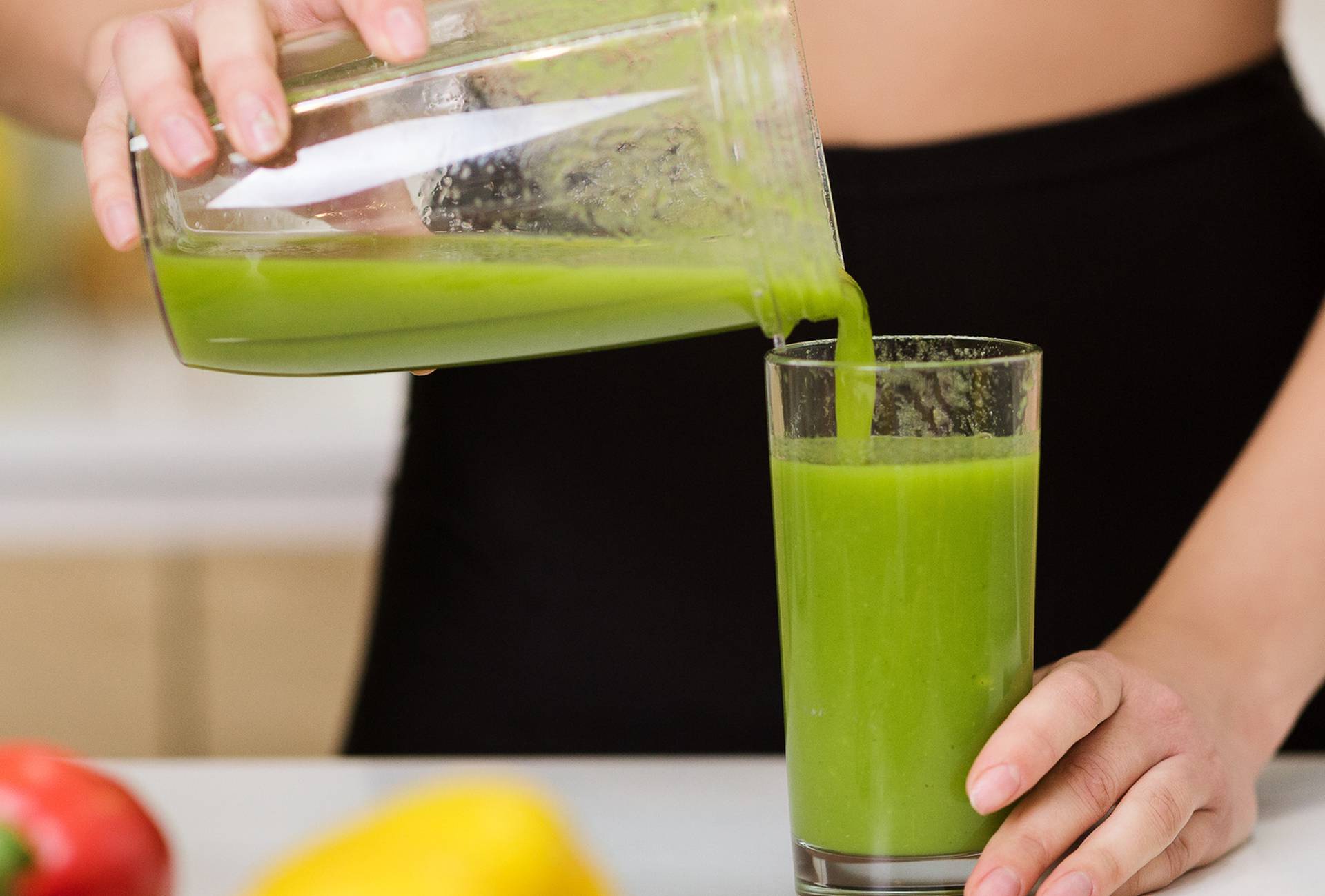 Healthy eating. Woman pouring detox shake to glass