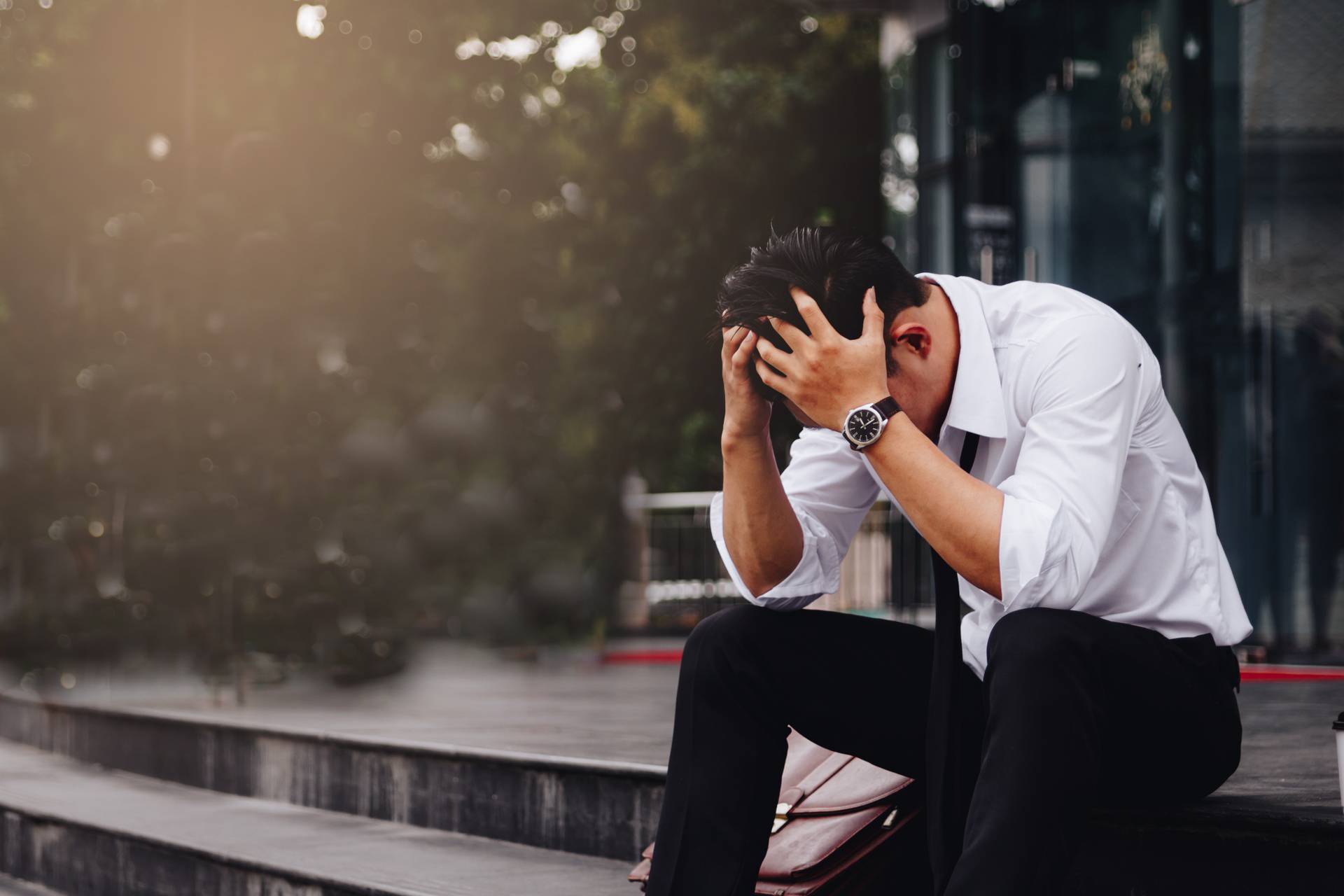 Asian young businessman stress sitting in front office with his 