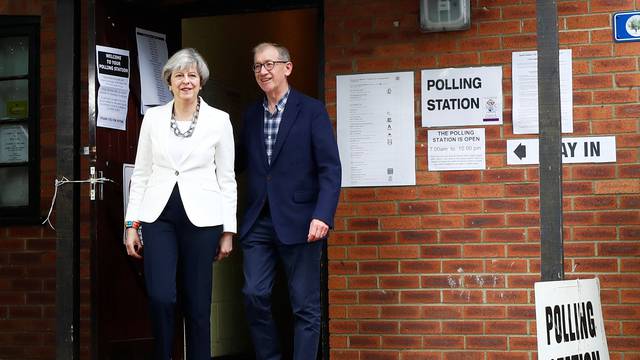 Britain's Primer Minister Theresa May and her husband Philip leave a polling station in Sonning