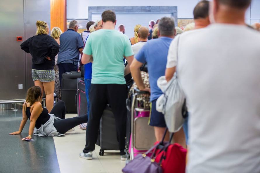 Thomas Cook passengers are seen at Las Palmas Airport after the world's oldest travel firm collapsed