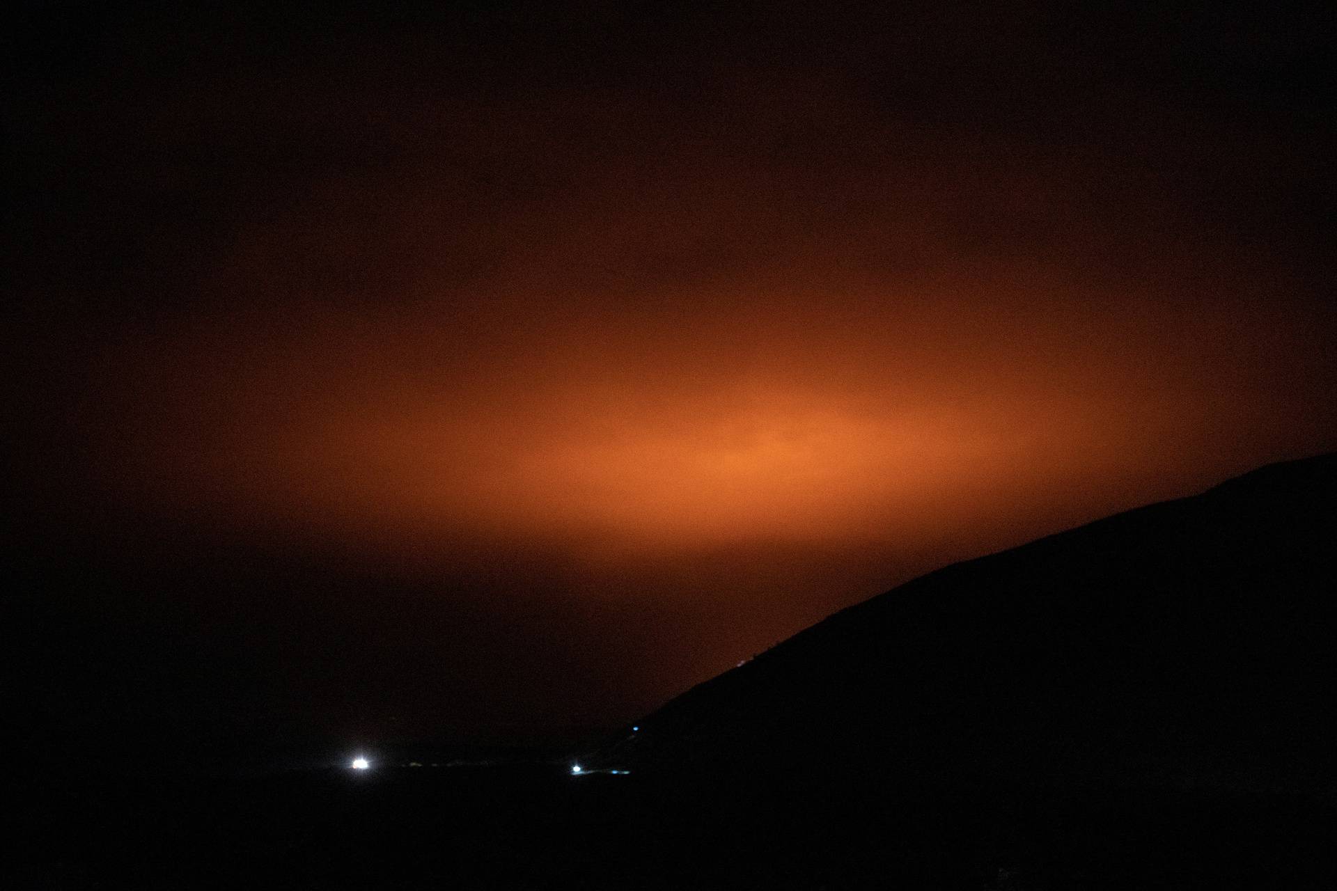 Light from the eruption of a volcano near Fagradalsfjall is seen in Grindavik