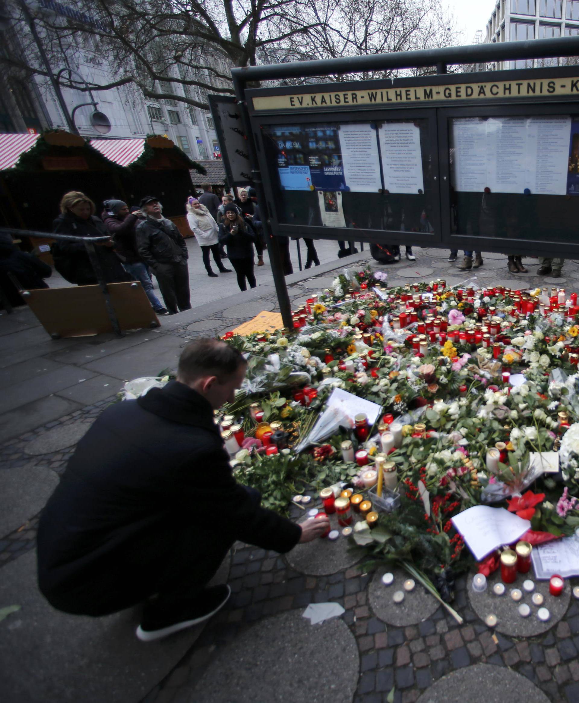 Flowers and candles are placed near the Christmas market in Berlin