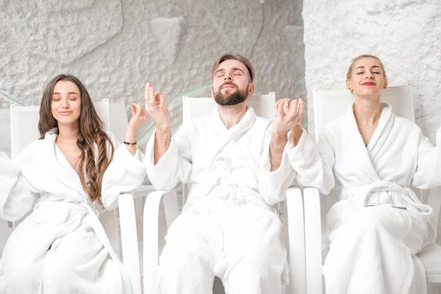 Three,Friends,In,Bathrobes,Meditating,In,The,Salt,Room