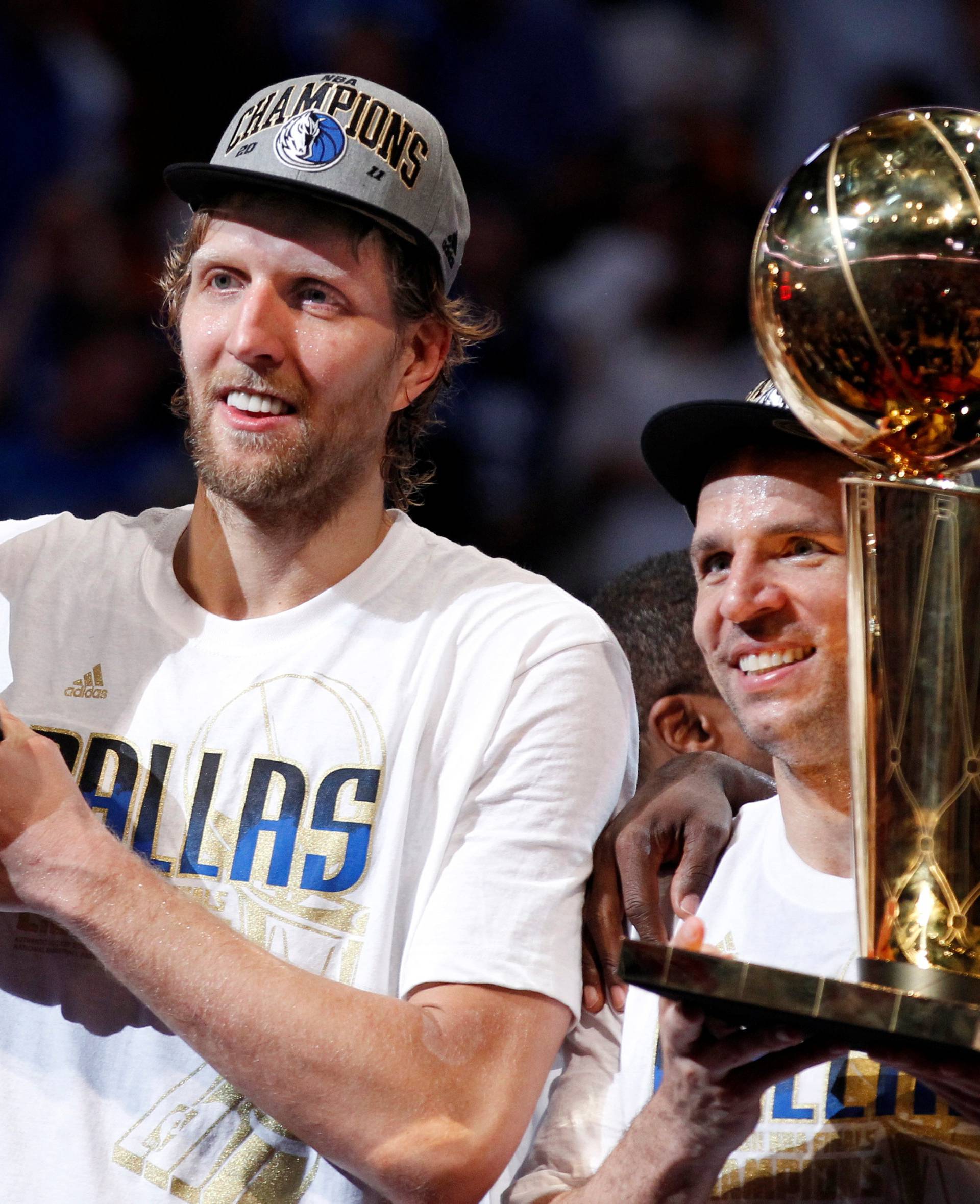 File Photo: Mavericks' Nowitzki holds the Bill Russell NBA Finals MVP trophy as Kidd holds the Larry O'Brien Championship Trophy after their team defeated the Heat to win the NBA Finals basketball series in Miami