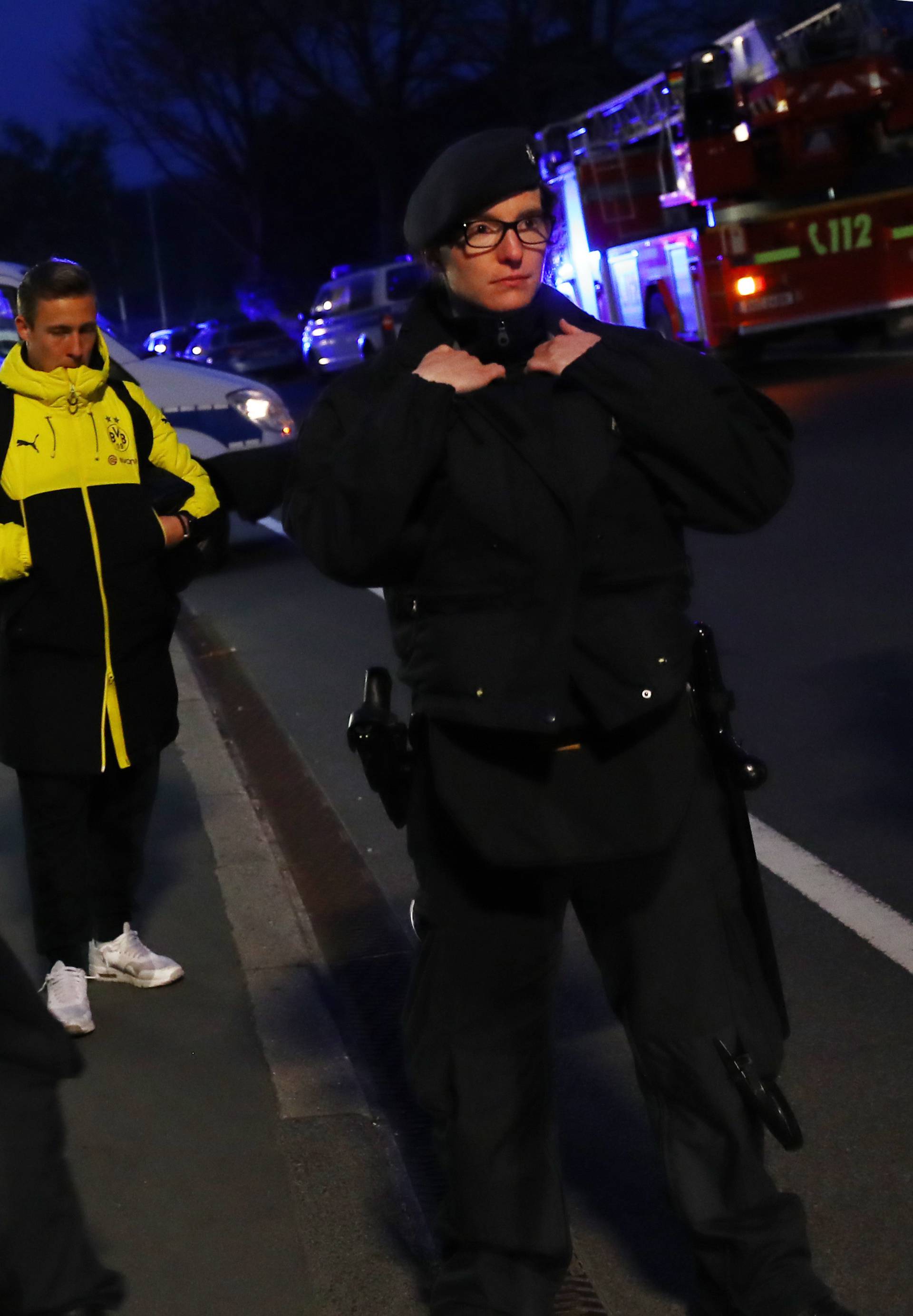 Borussia Dortmund's Felix Passlack with Police after an explosion by the Borussia Dortmund team bus near their hotel before the game