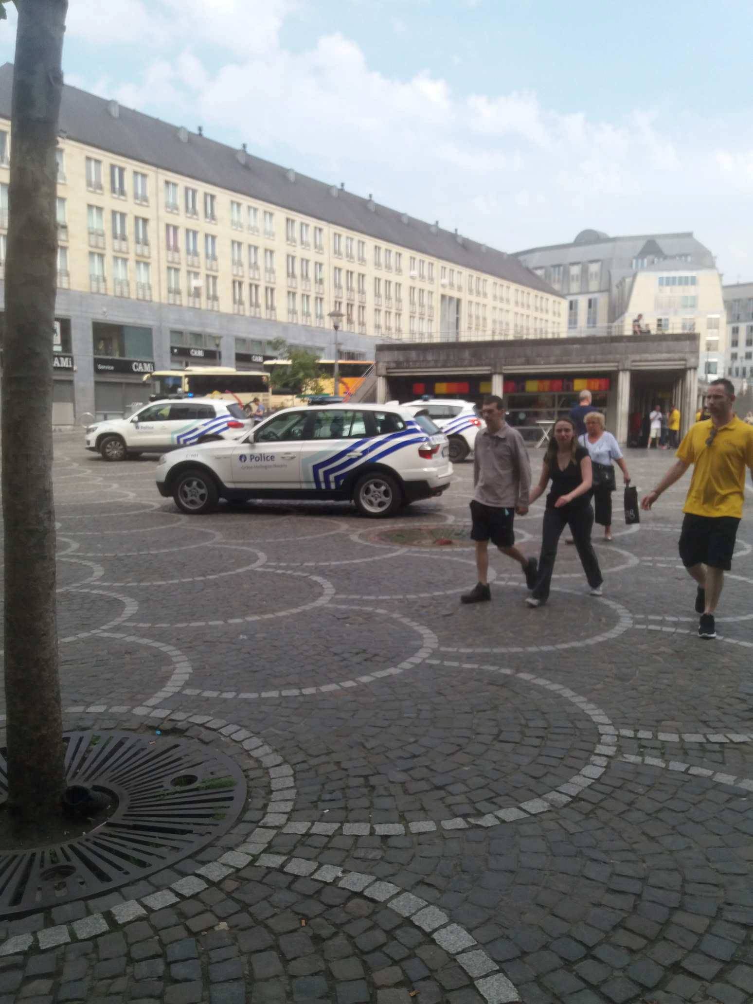 People are seen following a shooting in Liege