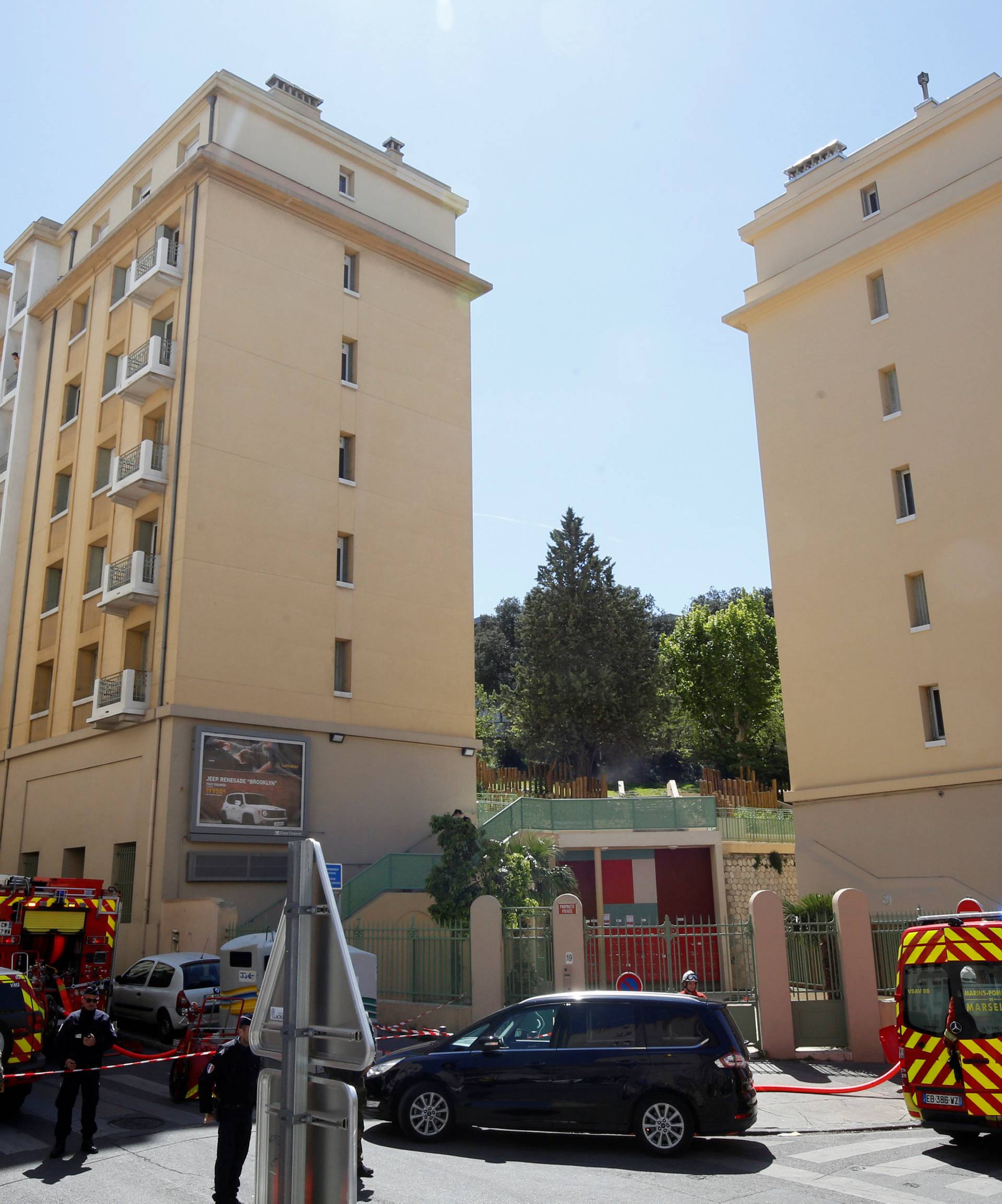 French firefighters secure the street as police conduct an investigation after two Frenchmen were arrested in Marseille