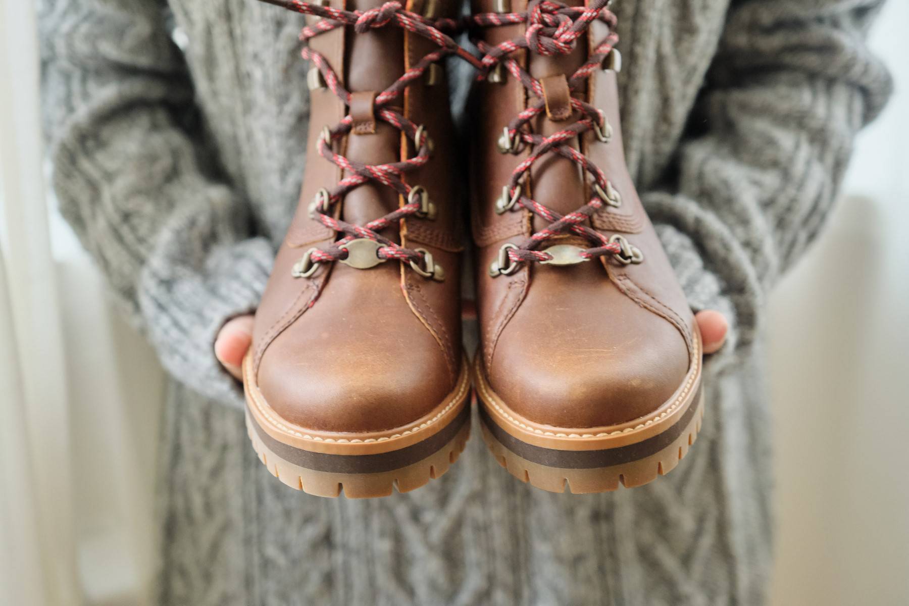 New womens leather brown waterproof winter boots in hands of female