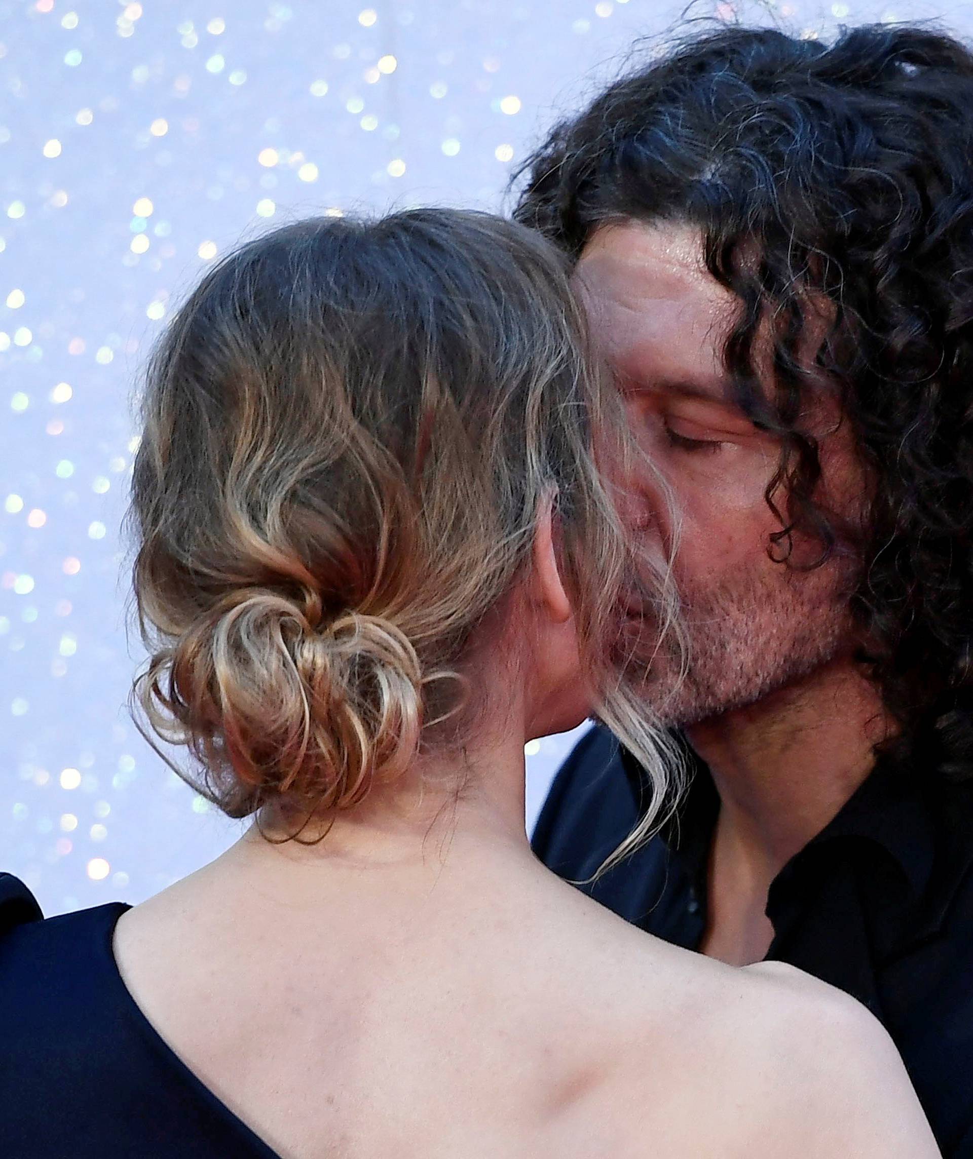 Renee Zellweger kisses an unknown man as she arrives for the world premiere of "Bridget Jones's Baby" at Leicester Square in London