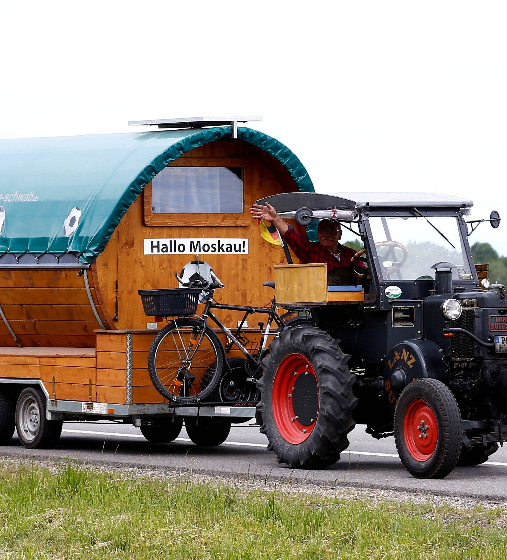 Soccer fan from Pforzheim, Germany, Wirth, 70, drives his tractor with a trailer to attend the FIFA 2018 World Cup in Russia, near the village of Yasen