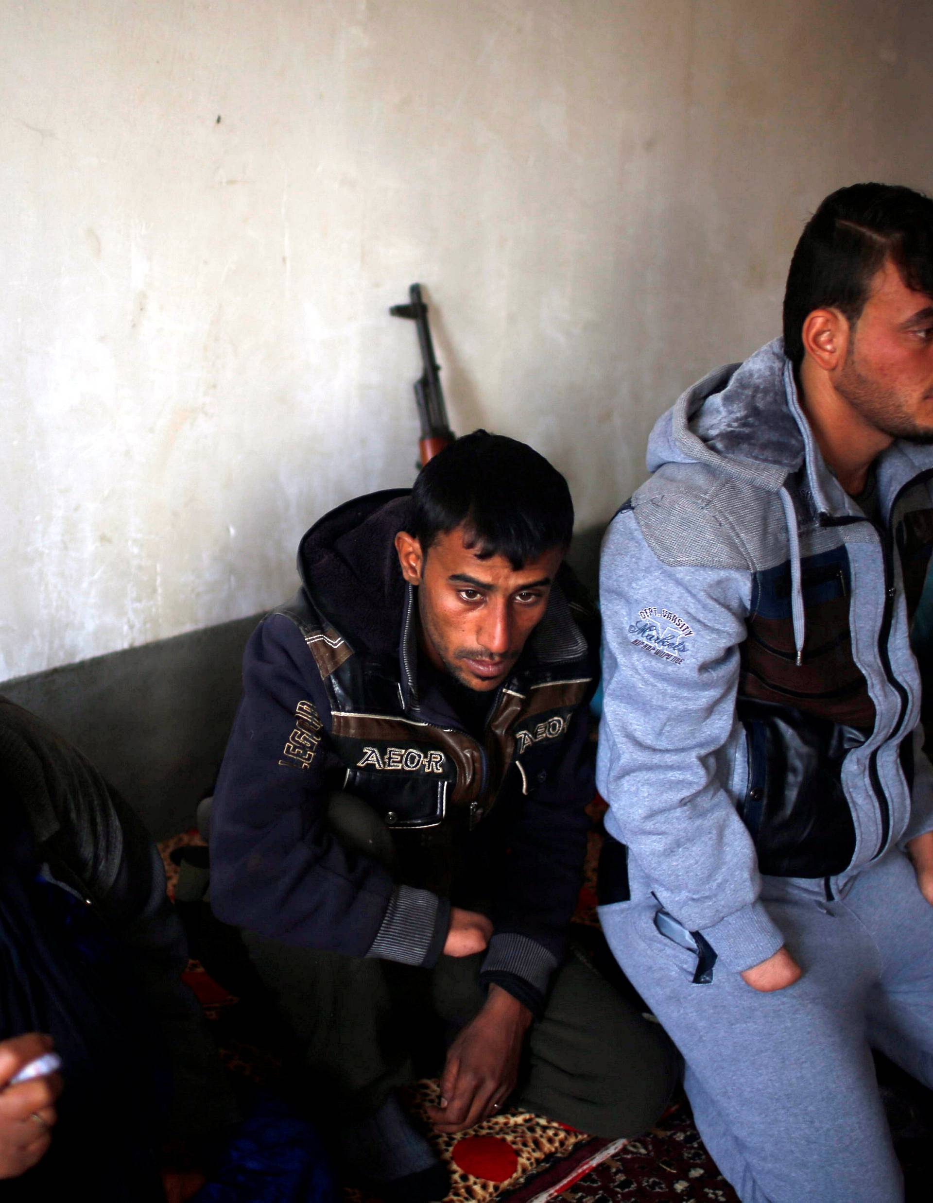 Azad Hassan and his brother Mohammad, whose hands were chopped off by Islamic State militants, sit with their aunt in a house at Nimrud village, south of Mosul