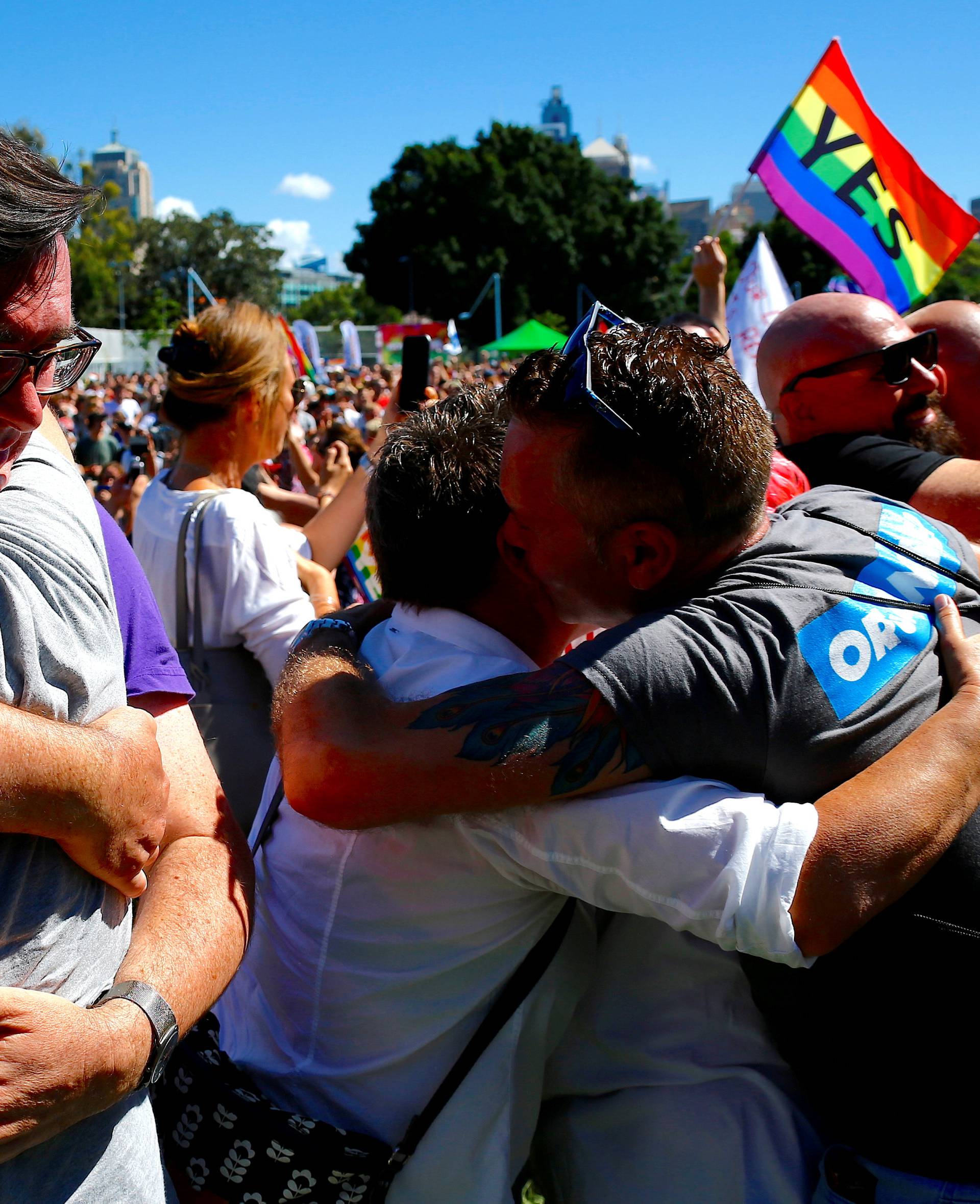 People celebrate after it was announced the majority of Australians support same-sex marriage in a national survey, at a rally in Sydney