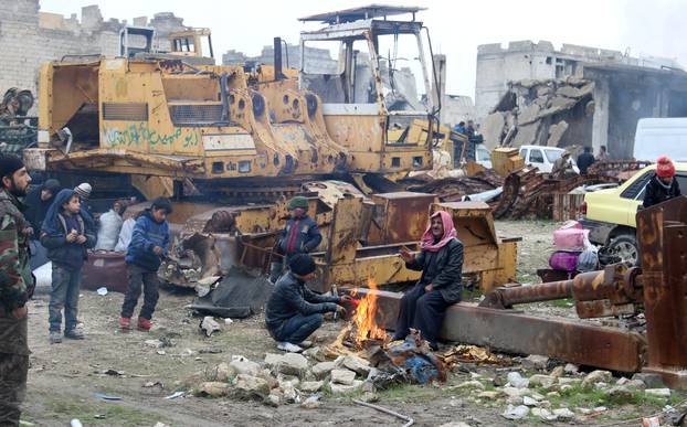 People wait to be evacuated from a rebel-held sector of eastern Aleppo