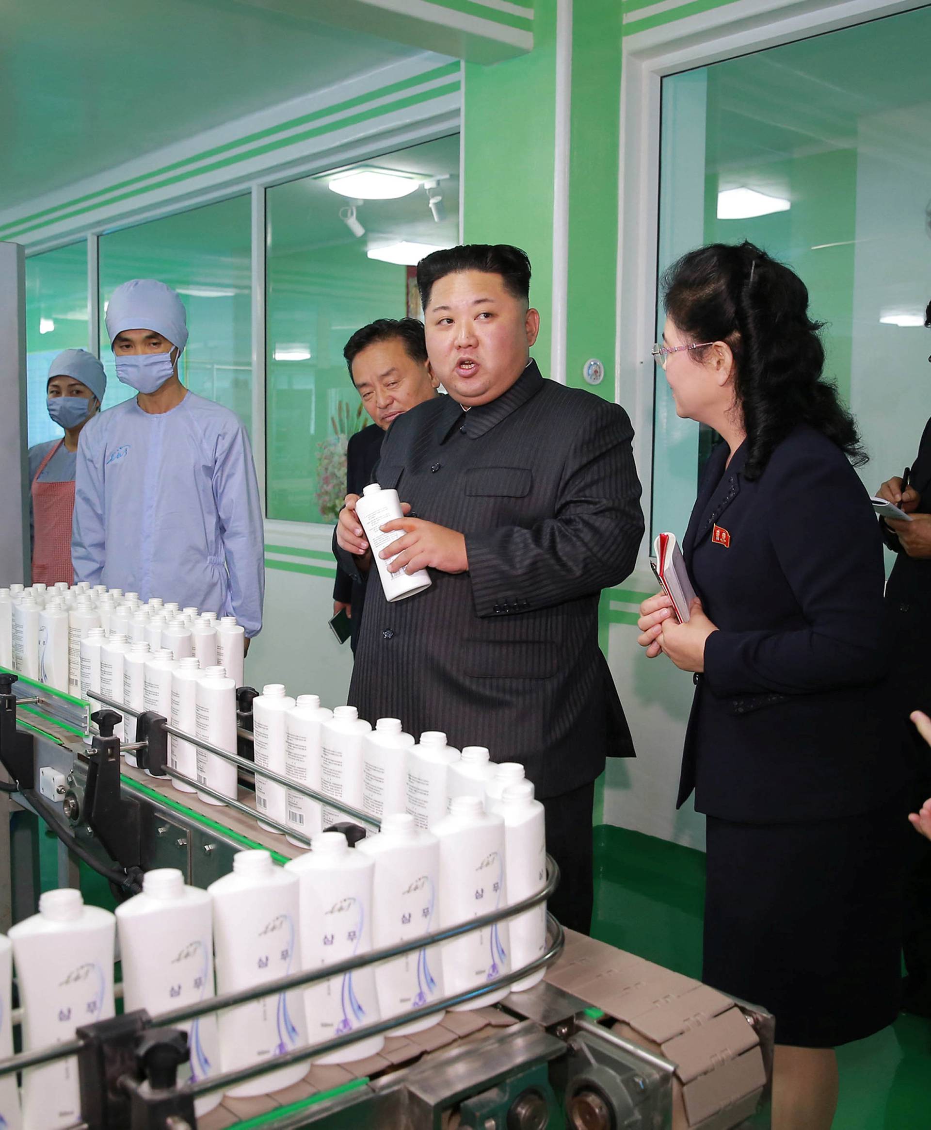 North Korean leader Kim Jong Un and wife Ri Sol Ju visit a cosmetics factory in this undated photo released by North Korea's Korean Central News Agency (KCNA) in Pyongyang