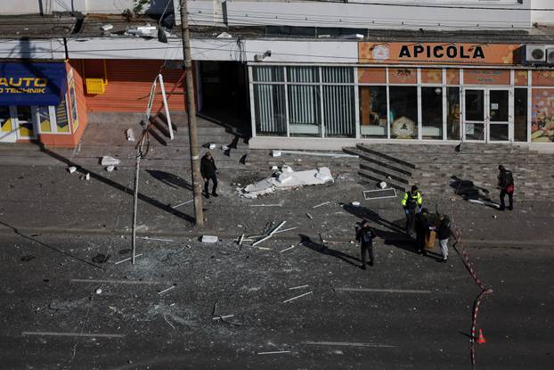 Law enforcement work on the site of an explosion at a residential block of flats following a drone hit in Galati