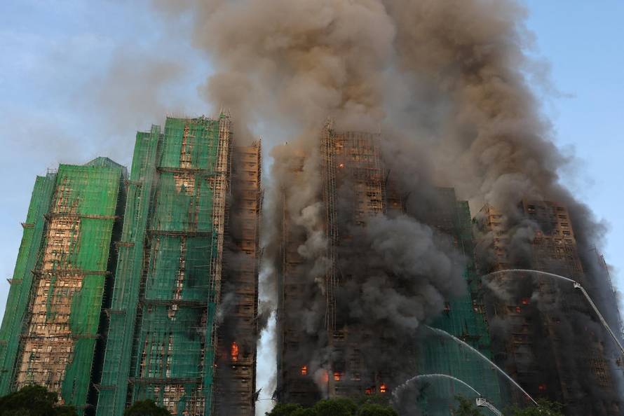 Flames engulf bamboo scaffolding across multiple buildings at Wang Fuk Court housing estate, in Tai Po