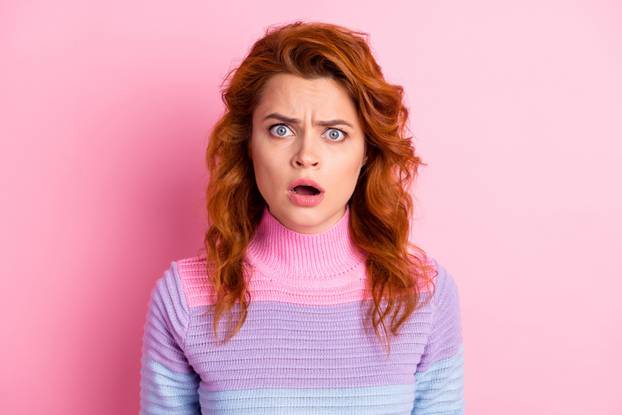 Photo portrait of upset shocked woman with open mouth isolated on pastel pink colored background