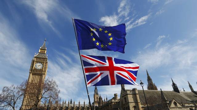 EU and Union flags fly above Parliament Square during a Unite for Europe march, in central London