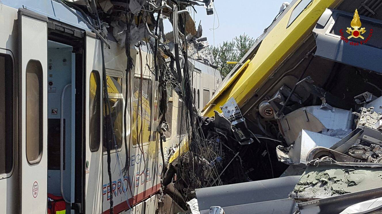 Two passenger trains are seen after a collision in the middle of an olive grove in the southern village of Corato