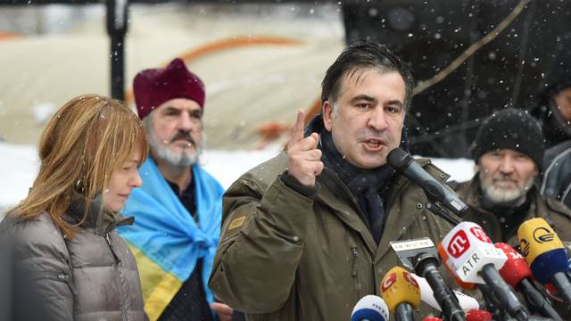 Former Georgian President Mikheil Saakashvili, accompanied by his wife Sandra Roelofs, addresses his supporters in front of the Parliament building in Kiev