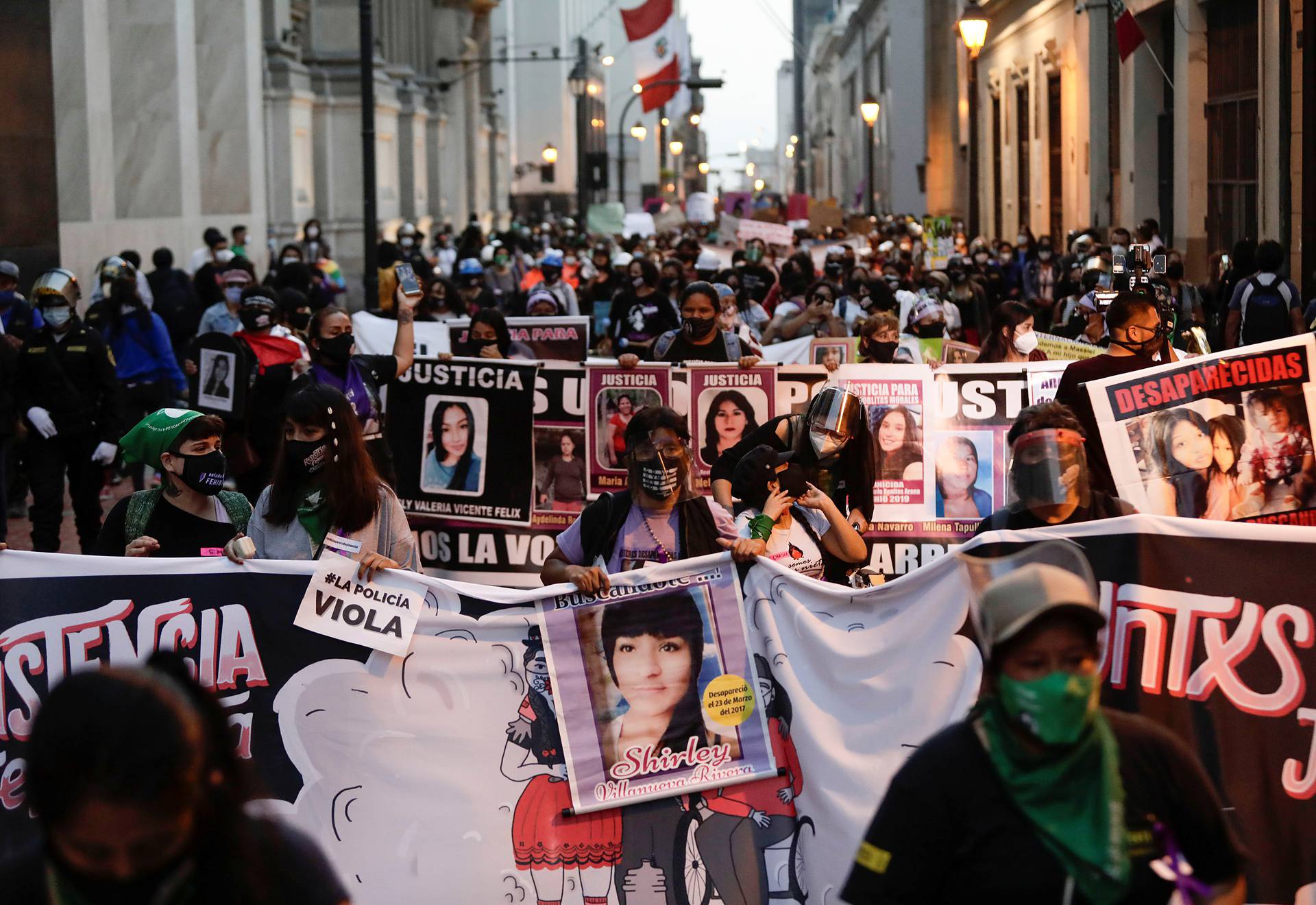 Demonstrators march during a protest to mark the International Day for the Elimination of Violence against Women, in Lima