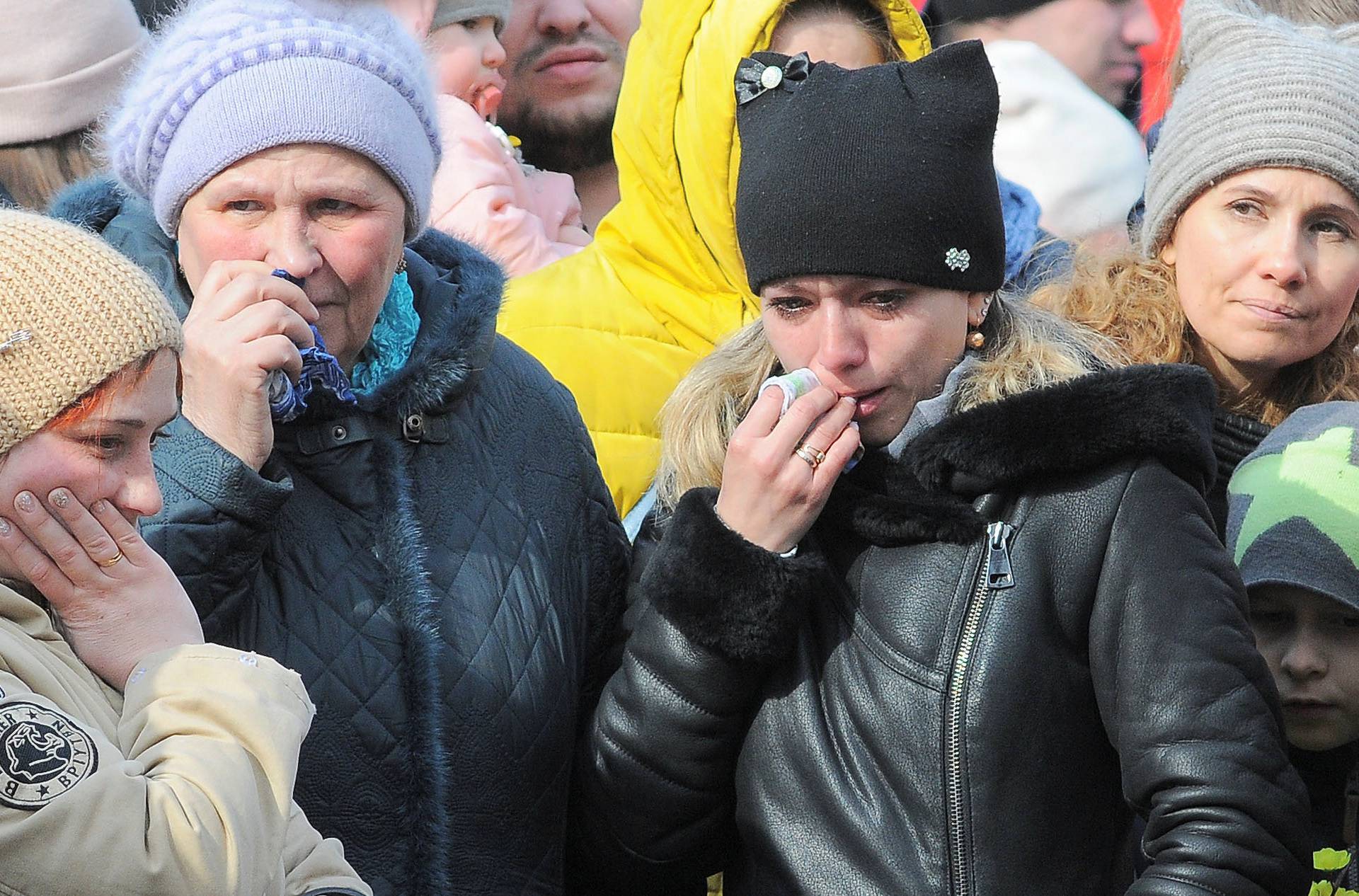 People mourn the victims of a shopping mall fire at a makeshift memorial in Kemerovo