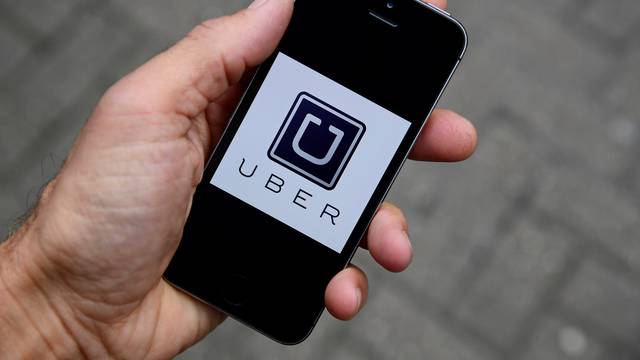 FILE PHOTO: The Uber app logo is seen on a mobile telephone