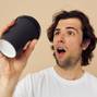 man in a white T-shirt with a black glass in hand Lifestyle unaltered