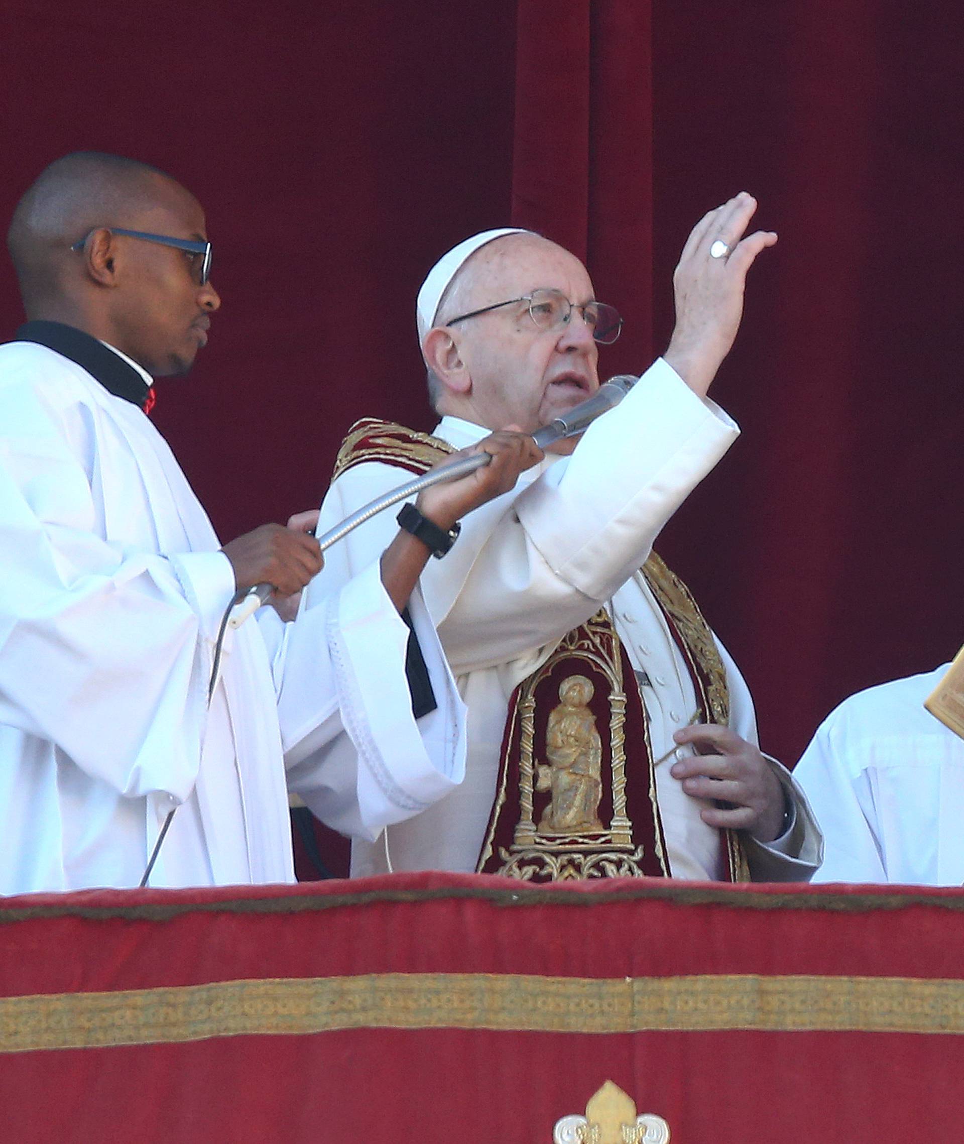Pope Francis makes a blessing during the "Urbi et Orbi" (to the city and the world) message from the balcony overlooking St. Peter's Square at the Vatican