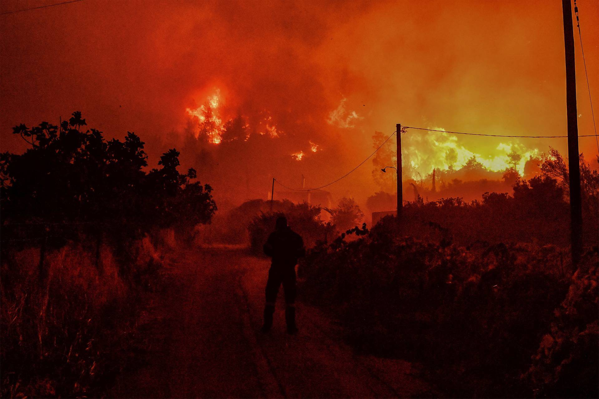 Wildfire burns next to the village of Ano Loutro, near Corinth