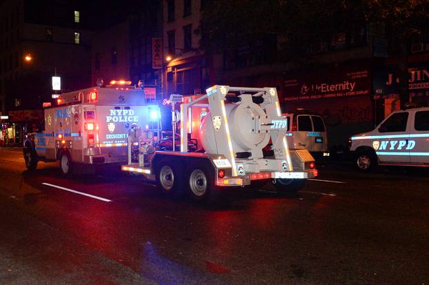 A police truck tows spherical chamber carrying second explosive device from near site of explosion in New York