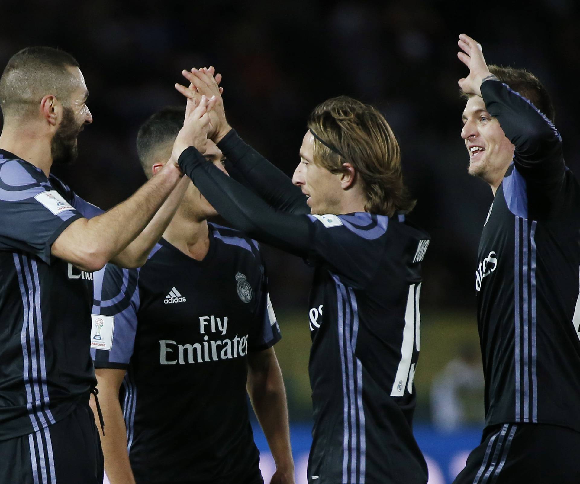 Real Madrid's Karim Benzema celebrates scoring their first goal with Luka Modric and teammates