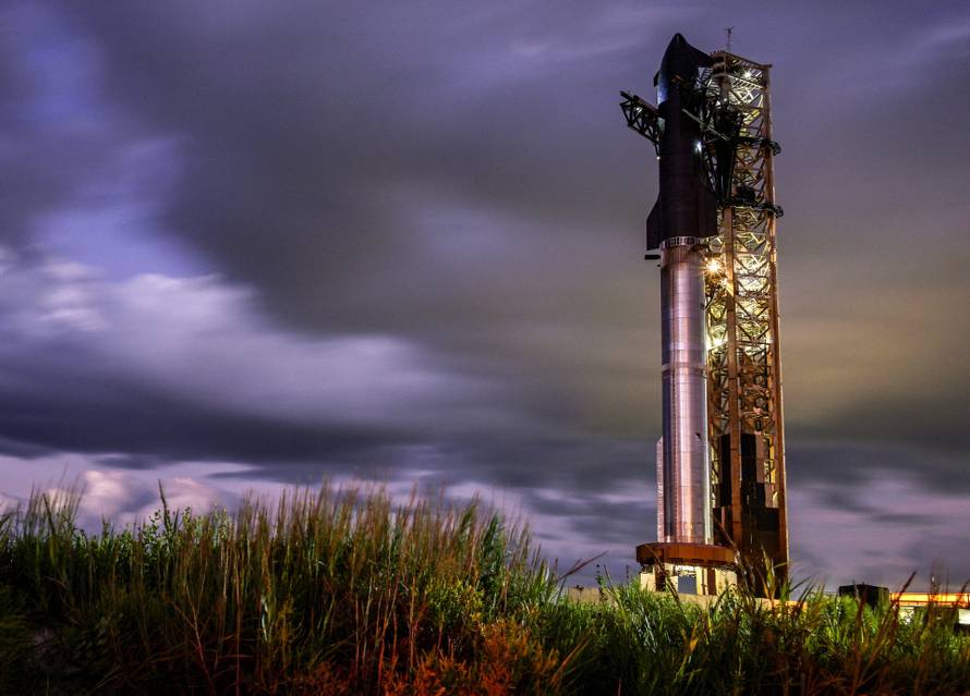 Preparations continue for the SpaceX Starship spacecraft as it sits atop the Super Heavy booster at sunrise before its 11th test flight