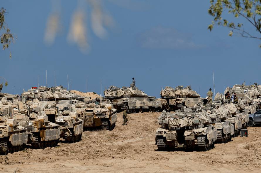 Israeli soldiers, tanks and armoured personnel carriers (APCs) near the Israel-Gaza border