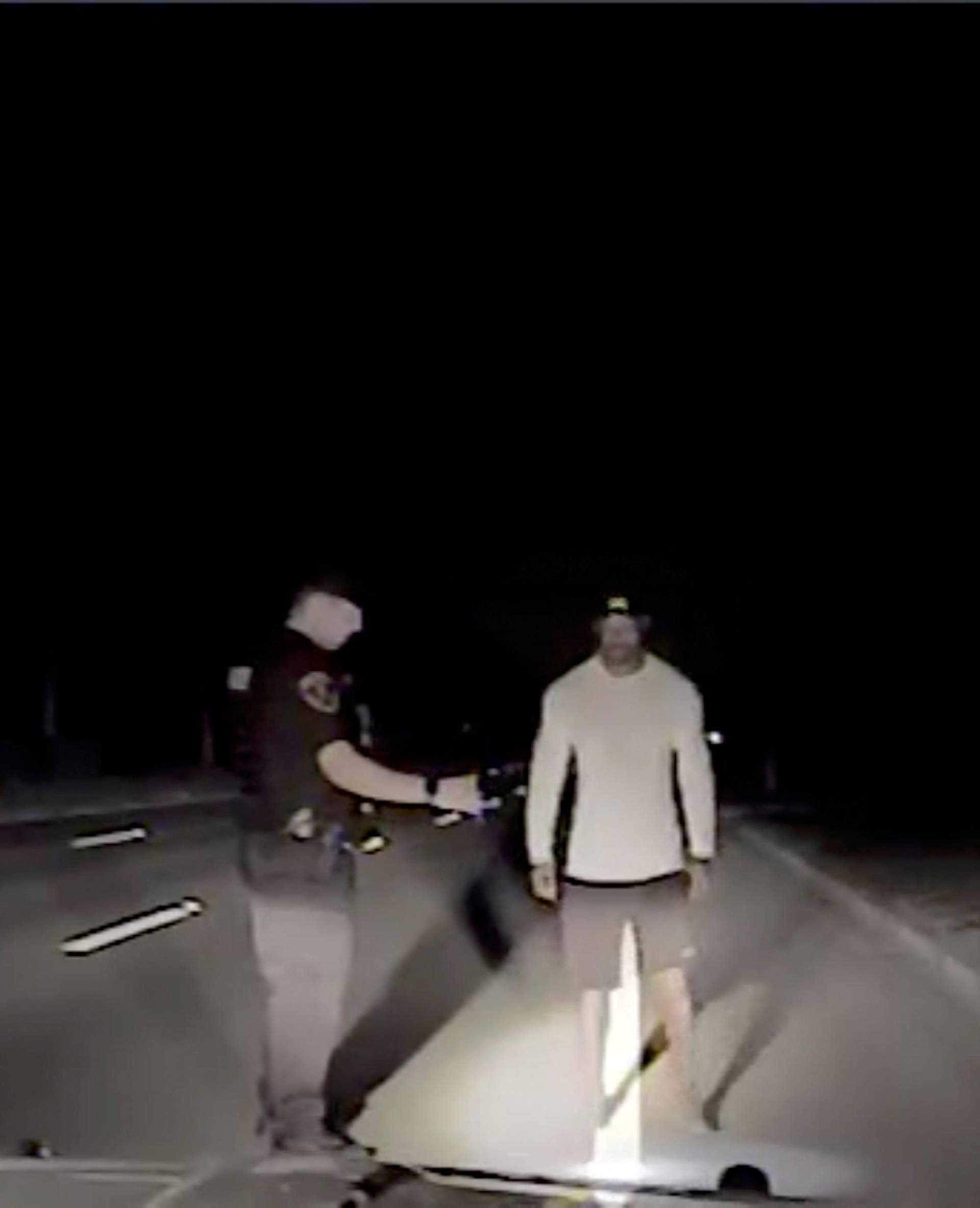 Tiger Woods is seen performing field sobriety tests following orders from a police officer in this still image from police dashcam video in Jupiter