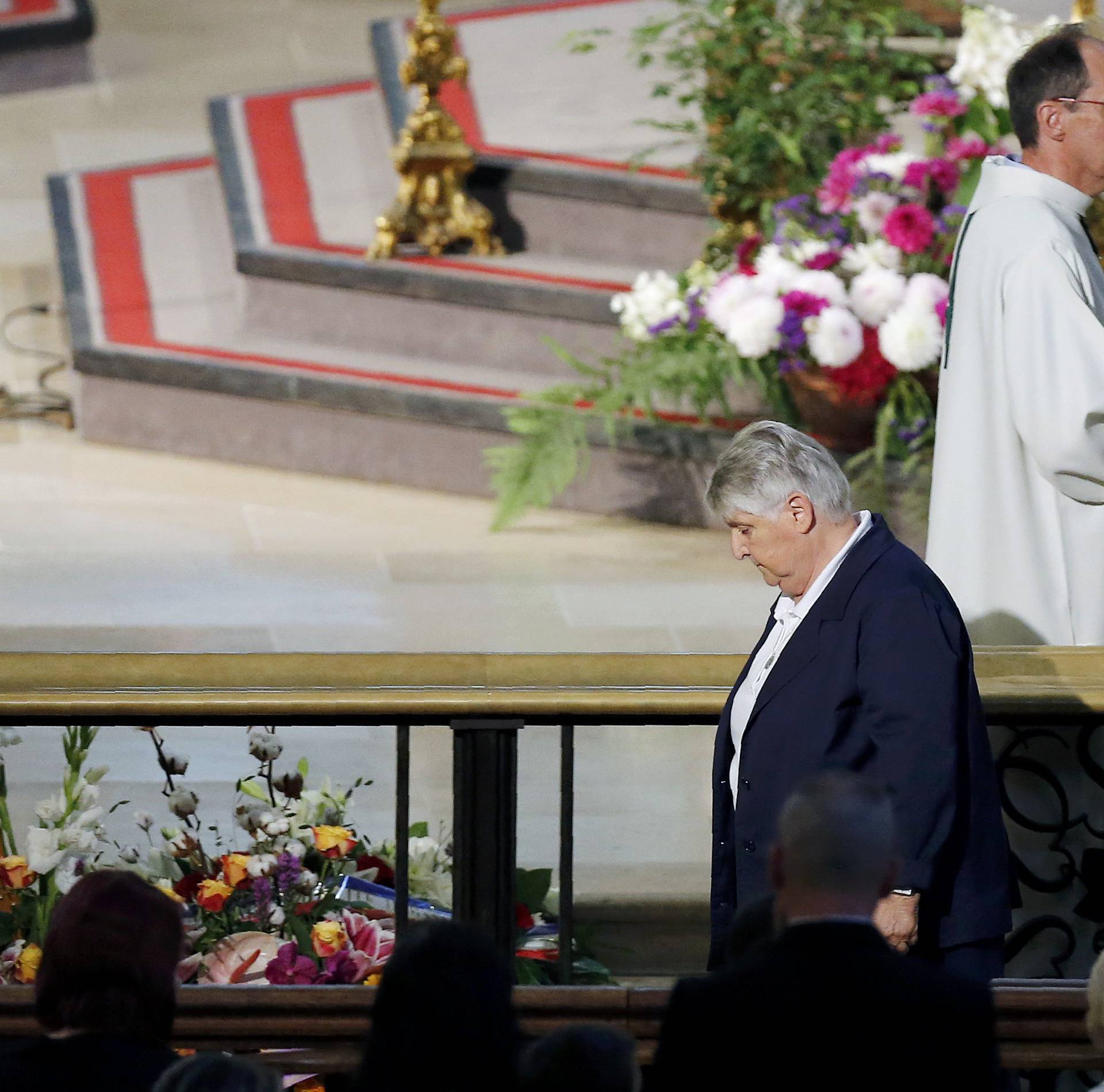 Sister Danielle Defosse walks away after she blessed the coffin of slain French parish priest Father Jacques Hamel at the Cathedral in Rouen