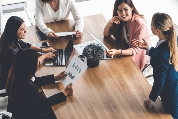 Businesswomen in Meeting, Laptop Computer on Table