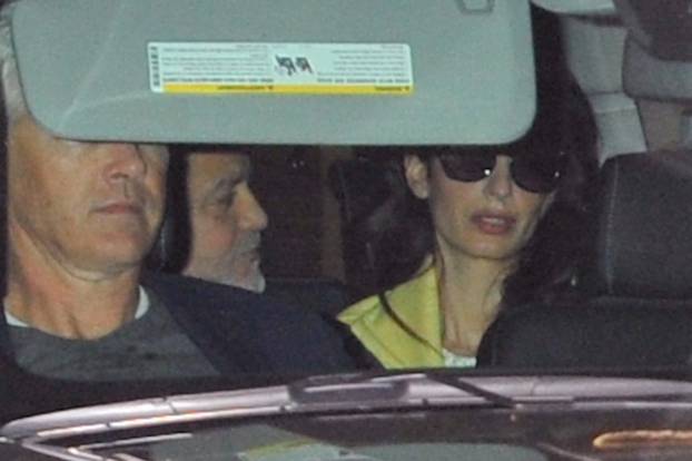 Amal Clooney seems upset as George Clooney speaks to her.